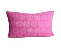 a pink pillow with white circles on it