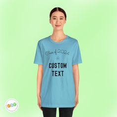 a woman wearing a blue t - shirt that says custom text