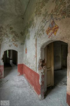 an empty room with painted walls and doorways