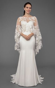 a woman in a white wedding dress with an open back and long sleeves, posing for the