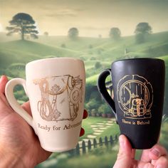 Discover the Charm and Warmth of "The Heart of the Shire" Set by Donovan Pottery Immerse yourself in the serene and delightful world of the Shire with The Heart of the Shire Set, a pair of beautifully designed mugs inspired by the beloved Hobbits. Each mug in this exclusive set features unique, hand-drawn illustrations in 22k gold, capturing the essence of the peaceful and joyful life in the Shire. Designs Included: Home is Behind" Mug: Featuring a charming depiction of a Hobbit door with a book Hobbit Door, Joyful Life, Hobbit Hole, The Shire, Gold Ceramic, Customer Testimonials, Eco Friendly Travel, Mug Set, Daily Ritual