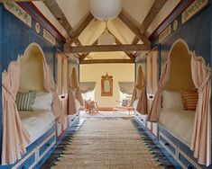 two beds in a room with blue walls and carpet