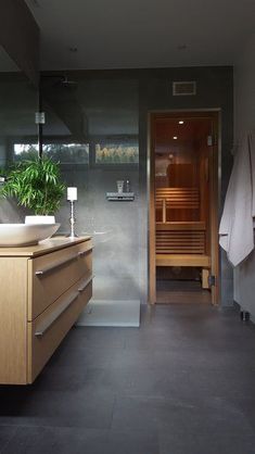 there is a bathroom with a plant in the bathtub