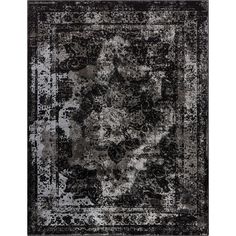 a black and white rug with an ornate design on the center, in front of a white background