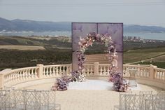 an outdoor ceremony setup with flowers and chairs