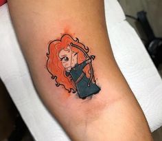 a woman's arm with a cartoon character tattoo on it