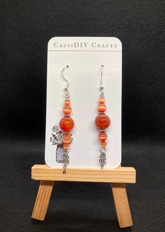 Sterling Silver hooks with orange sphere beads and stainless steel fringe chain Orange Carnelian Dangle Earrings, Orange Dangle Jewelry With Dangling Beads, Orange Jewelry With Dangling Beads, Orange Dangle Jewelry With Lobster Clasp, Nickel-free Orange Beaded Dangle Earrings, Orange Drop Earrings With Dangling Beads, Nickel-free Orange Beaded Drop Earrings, Orange Dangle Chandelier Earrings For Gift, Adjustable Dangle Earrings With Beaded Chain