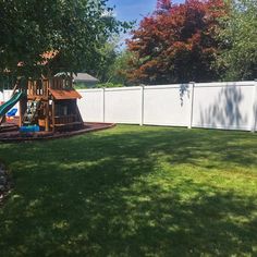 a backyard with a swing set and play area