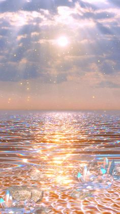 the sun shines brightly in the sky over water with ice flakes floating on it