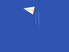 a paper airplane flying in the blue sky