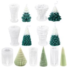 twelve small christmas trees in different shapes and sizes, all white with green decorations on them