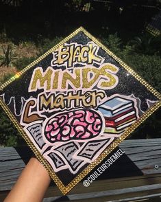 someone holding up a graduation cap with writing on it that says, black minds matter