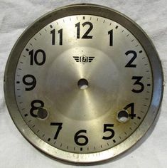 an old metal clock face with numbers on it