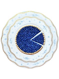 a blue and white plate with a pie in the middle on it's side