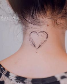 a woman with a heart tattoo on her neck