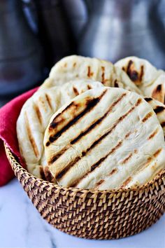 some pita bread in a basket on a table