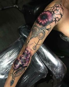 a woman's arm with flowers on it