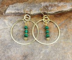 "A beautiful set of large statement gold plated earring hoops with beaded malachite drops. These wonderful fashion statement earrings are a perfect gift for any occasion for the woman in your life. They can be worn with many different styles of clothing and are perfect for both daytime and evening wear. COUPON CODES: Save 10% on purchases totaling $100 or more- enter coupon code 'SAVE10PERCENT' at checkout! Save 15% on purchases totaling $200 or more- enter coupon code 'SAVE15PERCENT' at  checkout! Follow my jewelry on Facebook at \"African Echoes Beads\" Follow my abstract mixed media paintings on Instagram @rodwimerfineart or... www.RodWimerFineArt.com" Elegant Green Natural Stone Hoop Earrings, Gold Bohemian Jewelry With Malachite, Gold Bohemian Malachite Jewelry, Brass Beaded Hoop Earrings As Gift, Beaded Brass Hoop Earrings For Gift, Gold Hoop Jewelry With Natural Stones, Beaded Gold-plated Earrings For Gifts, Gold-plated Beaded Earrings For Gifts, Gold Plated Beaded Earrings For Gifts