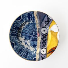 a blue and white plate with an abstract design on it's side, against a white background