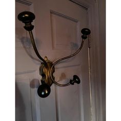 an old fashioned wall light hanging from the side of a door