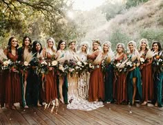 a group of women standing next to each other on a wooden floor in front of trees