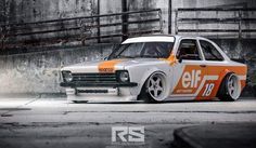 an orange and white car parked in front of a building