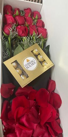 roses and chocolates in a box on a table