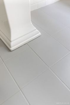 a white toilet sitting on top of a tiled floor