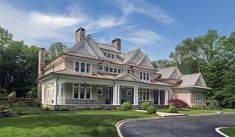 a large house in the middle of a lush green yard