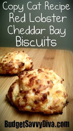 two cheddar bay biscuits sitting on top of a wooden cutting board with text overlay