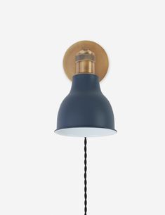 a blue lamp with a wooden shade on it's head and a black cord hanging from the side