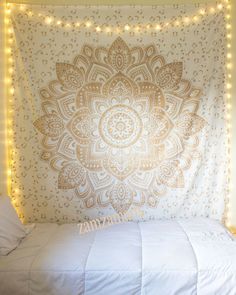 two pictures of a bed with lights on the headboard and an image of a wall hanging above it