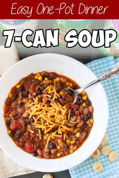 a white bowl filled with chili and beans on top of a blue checkered table cloth