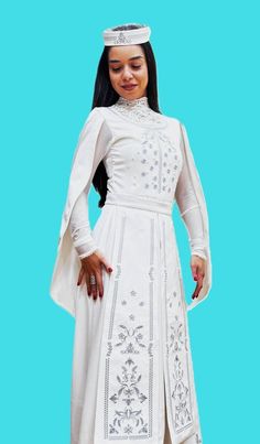 This Armenian Taraz is a traditional women's dress with embroidery that reflects the traditional patterns that emerged in Armenian culture through agriculture and crafts. The patterns form a unique ornament that attracts attention with its beauty and grace. Taraz emphasizes femininity and sophistication, and different patterns are combined into a unique ornament. With this Taraz there is also a headdress and an apron. This Taraz was designed and sewn for weddings, but it can be worn on other occ White Gown For Traditional Ceremonies, White Gown For Transitional Season Traditional Ceremonies, White Embroidered Dress With Traditional Patterns, Folk Style Wedding Dress For Eid, Traditional White Dresses For Ceremonies, Traditional Floor-length Embroidered Dress For Ceremonies, Traditional Long Sleeve Gown For Ceremonies, Traditional Wedding Gown With Traditional Patterns, Traditional White Gown For Transitional Seasons