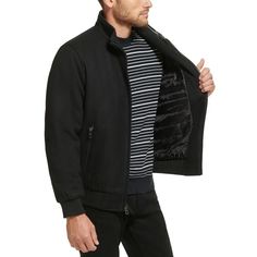 This wool bomber jacket with knit trim is a versatile coat that can be worn anywhere, from the boardroom to a night out on the town. It is a classic style that is sure to impress with its timeless look and sleek fabric. Heading to work or off the clock, keep warm while looking fashionably modern with this versatile bomber coat from Calvin Klein..Medium weight.Sits at waist.Regular fit.Stand collar; Zip-front closure.Single entry hand pockets with zipper closure.Inner channel quilt lining; Metal logo at back neck; Open cuffs with knit rib detail; Seam details at shoulder.Shell: Wool/polyester/nylon/acrylic/other fiber; Body lining: Nylon; Sleeve lining: Polyester.Dry clean only.Imported Classic Black Outerwear With Ribbed Collar, Winter Business Outerwear With Ribbed Cuffs, Classic Fall Sport Coat With Ribbed Cuffs, Classic Winter Track Jacket With Ribbed Cuffs, Classic Varsity Jacket With Ribbed Collar For Winter, Classic Winter Varsity Jacket With Ribbed Collar, Classic Wool Varsity Jacket For Winter, Classic Fitted Winter Track Jacket, Classic Winter Outerwear With Ribbed Collar