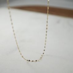 Introducing the Petal Chain, a beautiful and delicate 18" - 14K Gold Yellow Flat Oval Disc Chain that adds a touch of sparkle to any outfit. Made with solid gold, this chain is sure to catch the eye and make a statement. Material: 14kt Yellow Gold Chain Width: 1.2mm Length: 18" 14k Yellow Gold Station Necklace With Adjustable Chain, Delicate 14k Gold Charm Necklace With Cable Chain, Delicate 14k Gold Necklace With Paperclip Chain, Minimalist 14k Gold Delicate Chain Necklace, 14k Yellow Gold Station Necklace With Delicate Chain, Link Delicate Chain Necklace For Anniversary, Delicate Link Chain Necklace For Anniversary, 14k Rose Gold Filled Necklaces With Cable Chain, Delicate Chain Necklace As A Gift