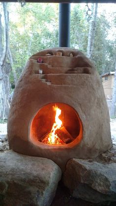 an outdoor oven with fire in it