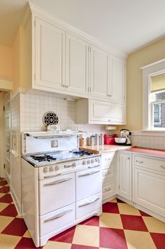 a white stove top oven sitting inside of a kitchen