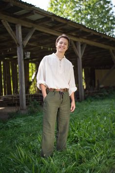 Summery stand-up collar shirt made from a hemp-cotton blend. Lacing at the neckline with loops instead of sewn buttonholes. Wide cut sleeve with buttoned, wide cuff at the wrist. The fabric with hemp fibres ensures a pleasant wearing comfort even in hot temperatures. Material: fabric mix of 50% hemp / 50% cotton, Colors: olive green, natural, ochre Manufactured: Fair Trade production in Nepal (cooperation partner of Get Natural) Washing recommendation: 30o - 40o degree gentle cycle Traditional German Outfits Men, Mens Medieval Costumes, Cottage Male Outfits, Easy Male Ren Fair Costume, Mens Hobbit Outfit, Forest Aesthetic Outfit Male, Hobbit Outfits Men, Faerie Clothes Men