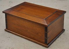 a wooden box sitting on top of a cement floor