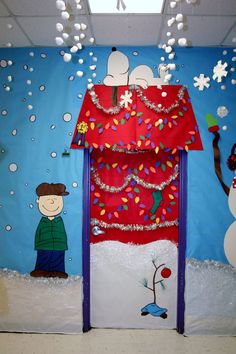 a room decorated for christmas with snowmen and decorations on the walls, including a door