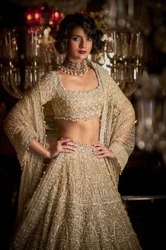 This lehenga set features intricate embroidery in pearl, sequin and silver thread. The blouse has pearl and crystal details at the neckline and shows tassels at the elbow. It is paired with heavy all-over embroidered dupatta. The border is scalloped and shows pearl and crystal drops. DELIVERY TIMEPlease allow 8-12 weeks for your outfit to arrive. FABRIC DETAILSLehenga - Net / Dupatta - Net Professional cleaning only. Pearl Lehenga, Reception Outfits, Indian Bridal Photos, Canada Fashion, Lehenga Designs Simple, Gold Skirt, Desi Fashion Casual, Luxury Wear, Embroidered Dupatta