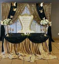 an elaborately decorated table with gold and black drapes