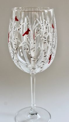 a wine glass with red birds on it