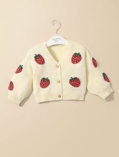 Super Adorable Baby Girl Strawberry Knit Cardigan Sweater – a delightful addition to her fall, winter, and autumn wardrobe! Crafted with care, this sweet cardigan features charming strawberry motifs in a cozy knit. Perfect for keeping her warm in style, this sweater is versatile and seasonally appropriate. Whether it's a crisp fall day or a chilly winter evening, dress your baby girl in this adorable piece for a touch of fruity charm and cozy comfort.Composition:100% Acrylic Cute White Outerwear With Buttons, White Cute Outerwear With Buttons, Cute White Sweater With Buttons, Winter Evening Dress, Strawberry Knit, Winter Evening, Autumn Wardrobe, Striped Bodysuit, Button Up Cardigan