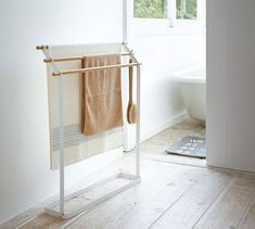 a towel rack in the corner of a bathroom