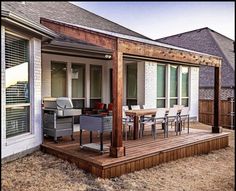 a patio with table and chairs next to a house