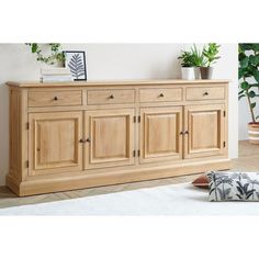 the sideboard is made from wood and has four doors, two drawers and one drawer