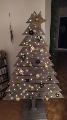 a wooden christmas tree with lights on it