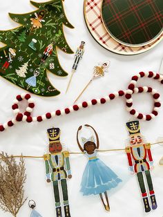 christmas decorations are displayed on a table with nutcrackers